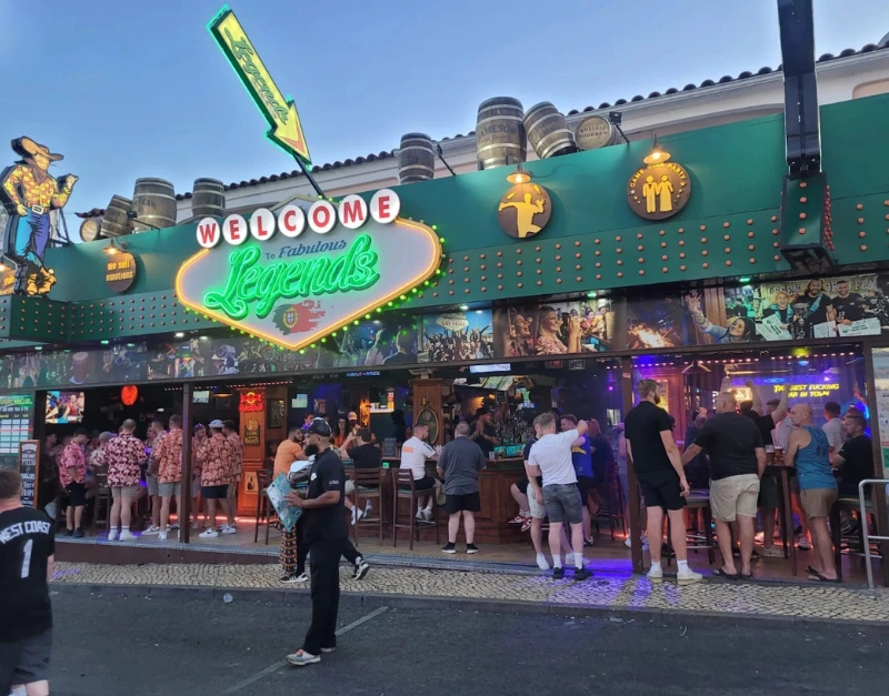 The Strip in Albufeira lined with bars and neon signs at night